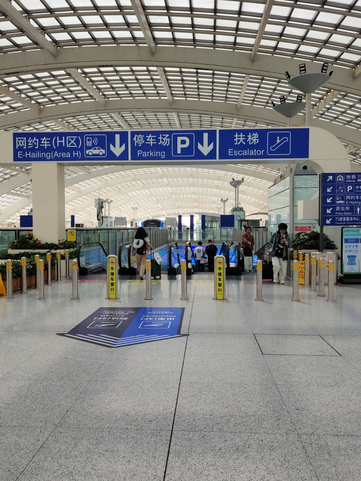 Escalator down to transport area at Beijing airport