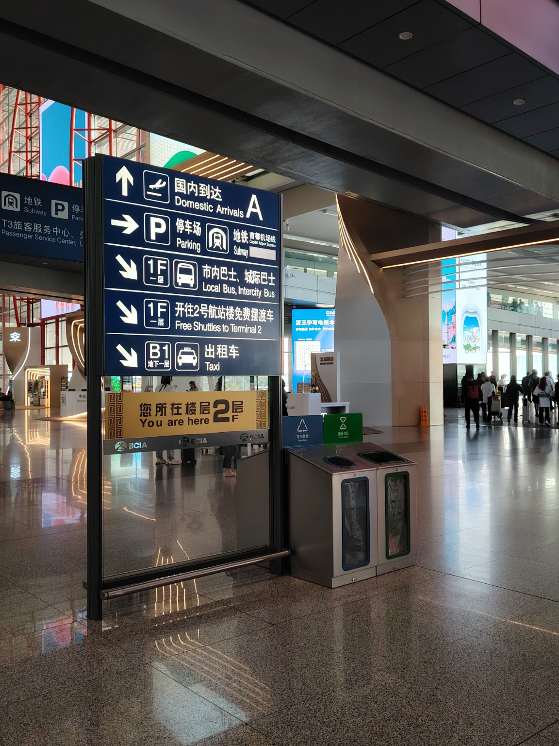 Escalator and elevator signs to taxi bus and e-hailing at Beijing Capital Airport