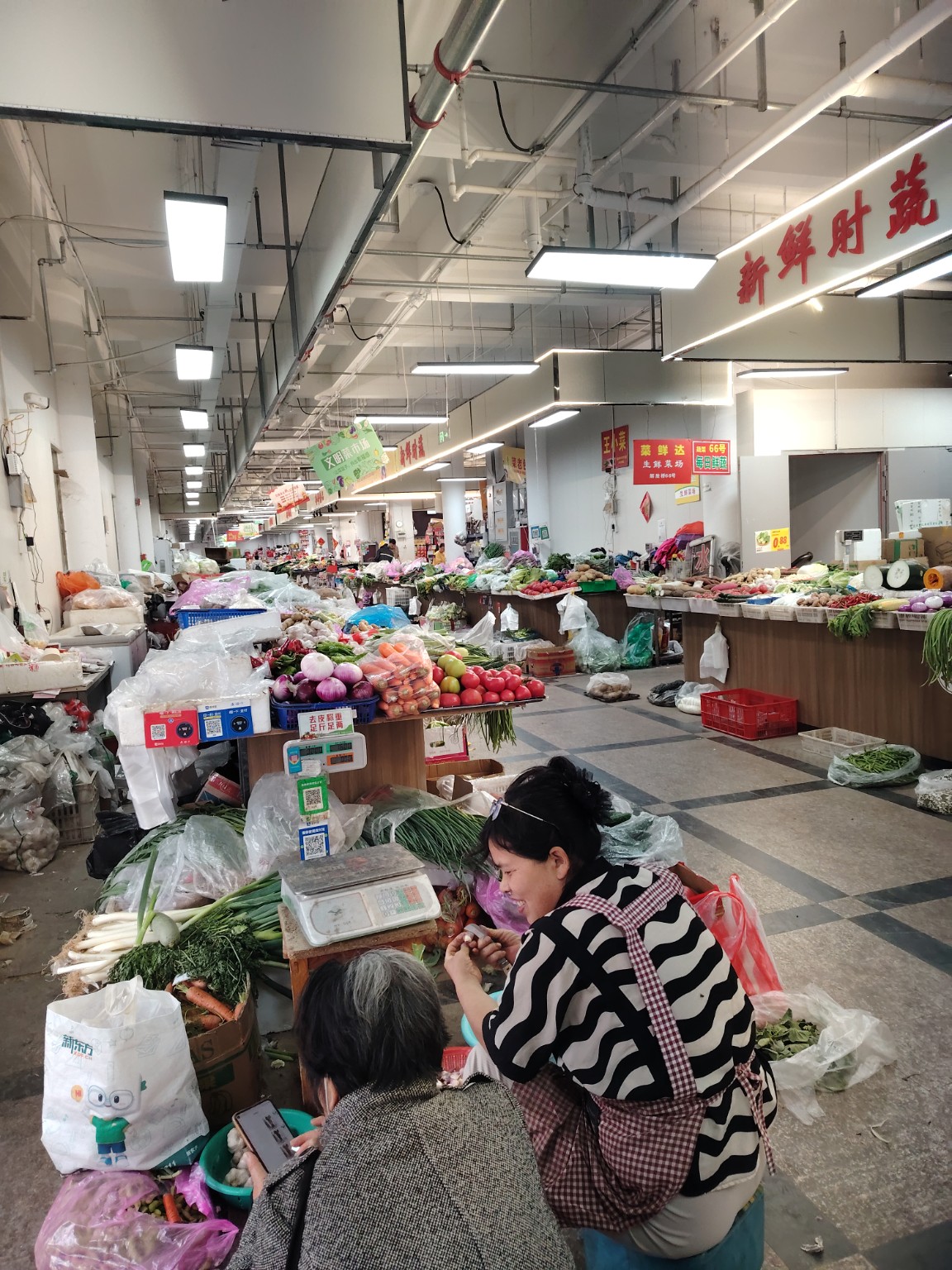 Friendly staff working in a Beijing local market
